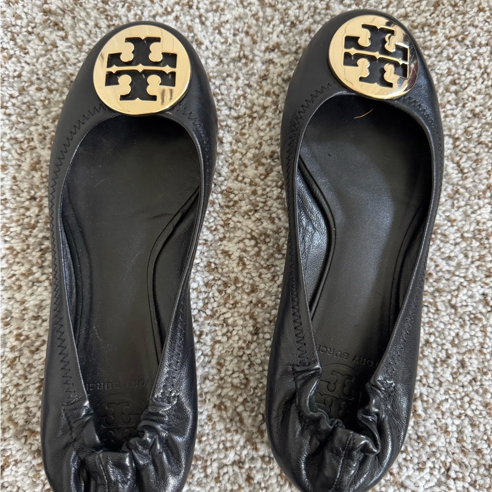 Tory Burch Black and Gold Flats with Logo Medallion